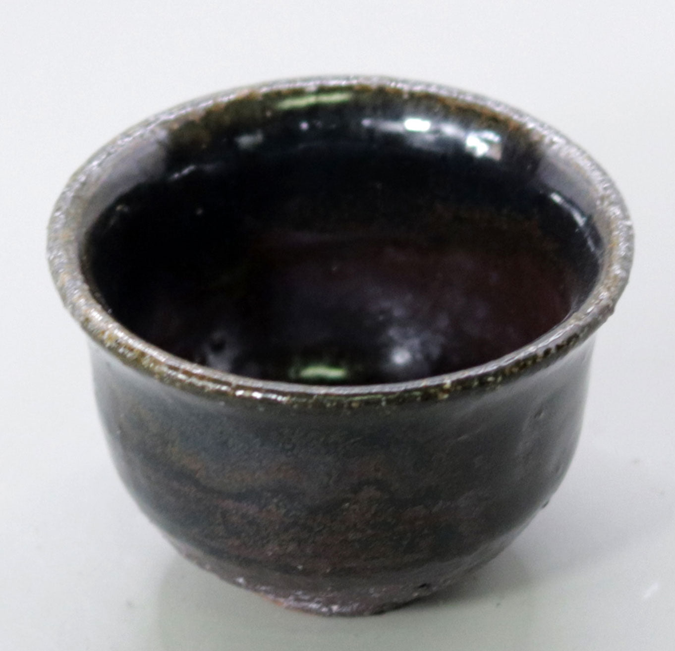 Iron glazed sake cup made from the foundation of the East Pagoda of Yakushiji Temple by Rakusai Bisai