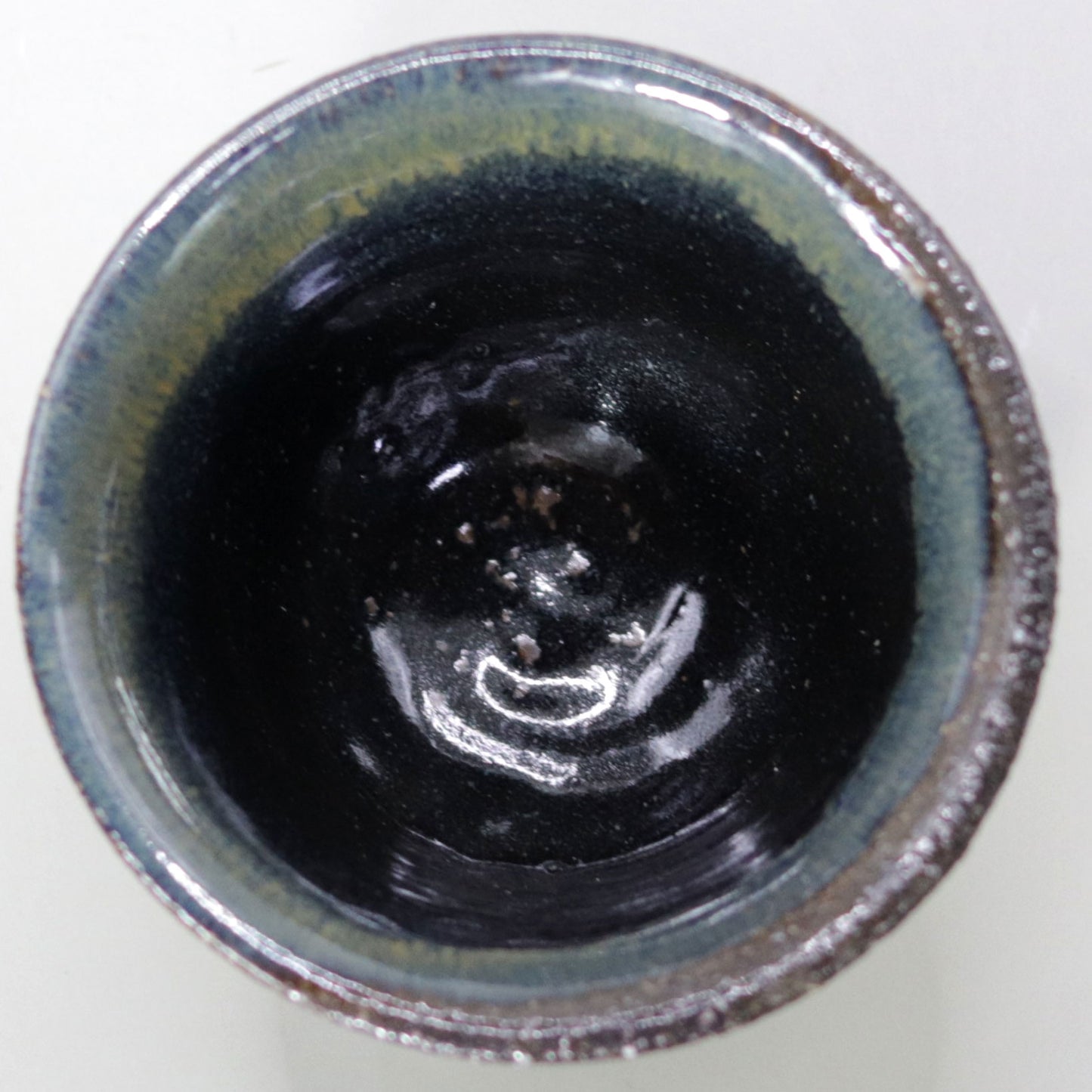 Iron glazed sake cup made from the foundation of the East Pagoda of Yakushiji Temple by Rakusai Bisai