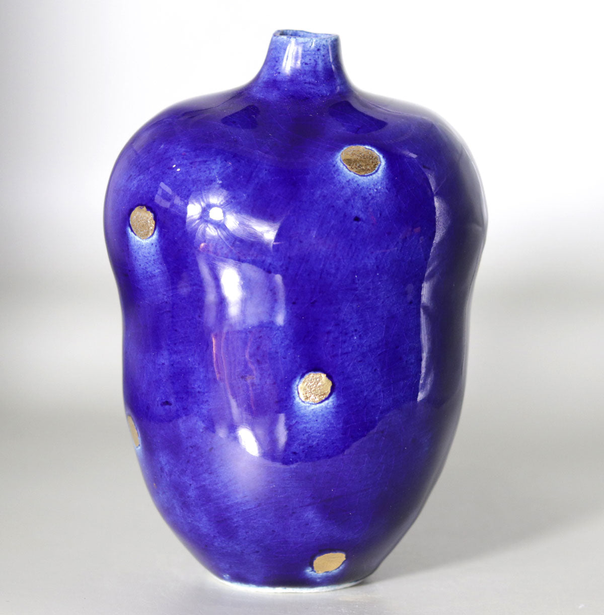 Blue vase with gold accents by Yasushi Fujihira