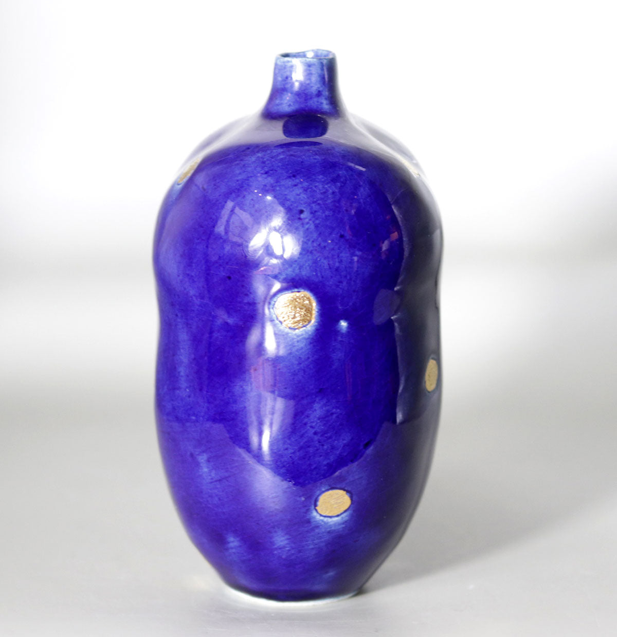 Blue vase with gold accents by Yasushi Fujihira