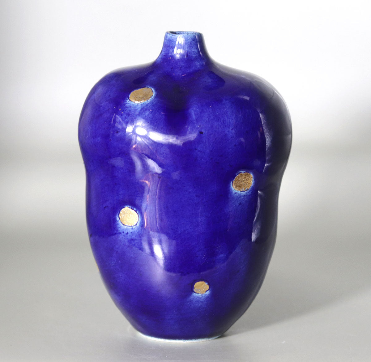 Blue vase with gold accents by Yasushi Fujihira