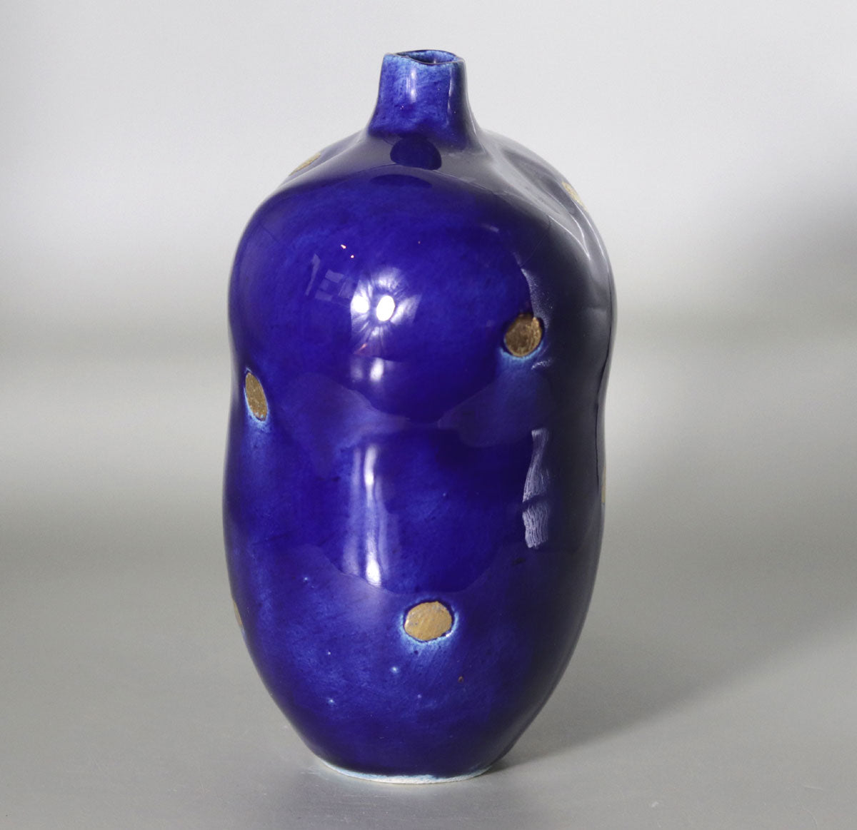 Blue vase with gold accents by Yasushi Fujihira