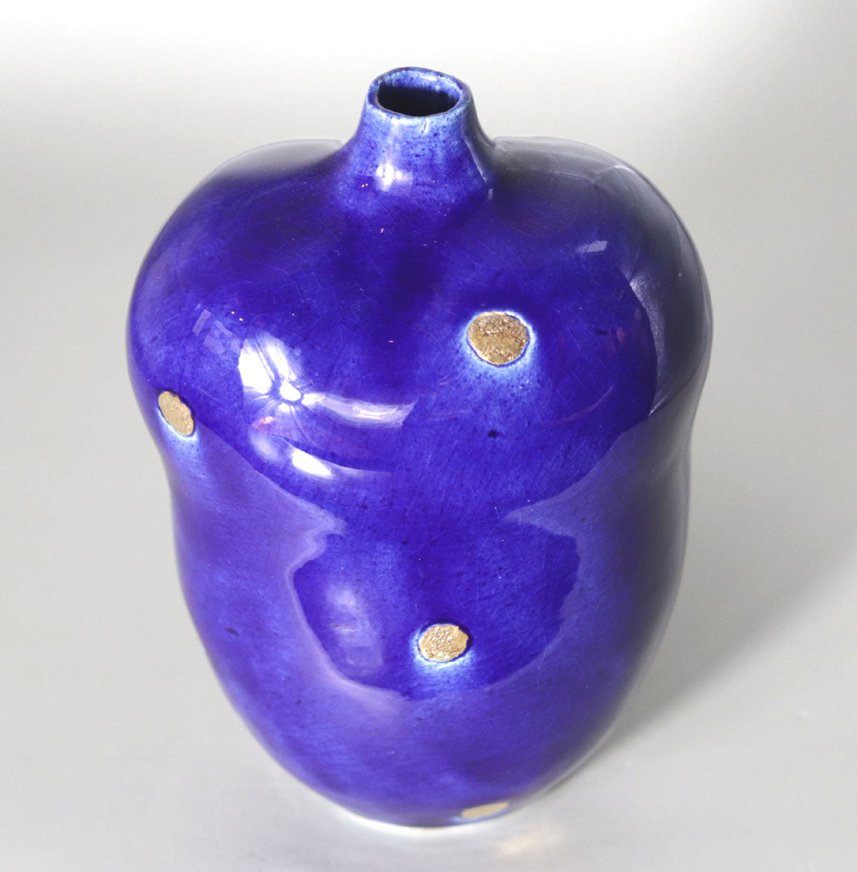 Blue vase with gold accents by Yasushi Fujihira