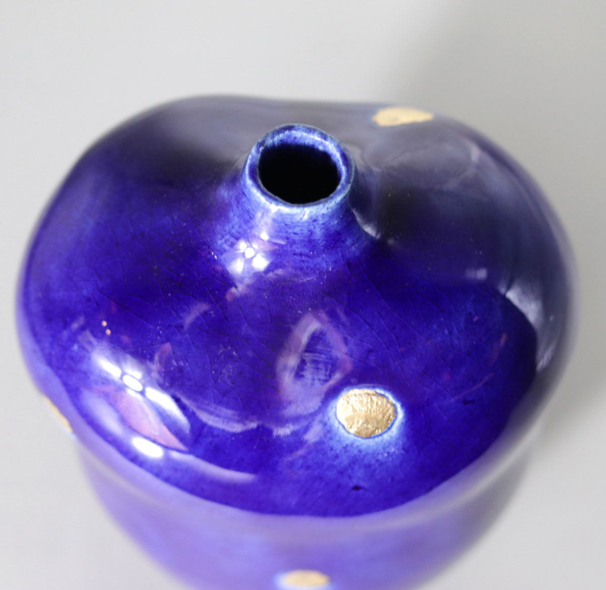 Blue vase with gold accents by Yasushi Fujihira