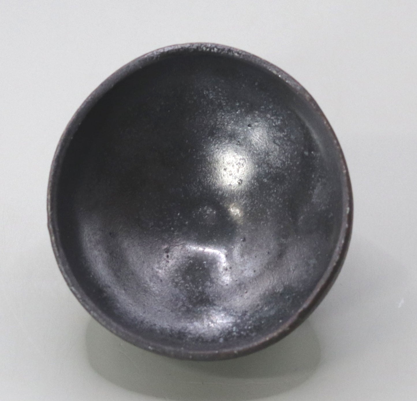 Iron glazed sake cup by Yuichi Ikai