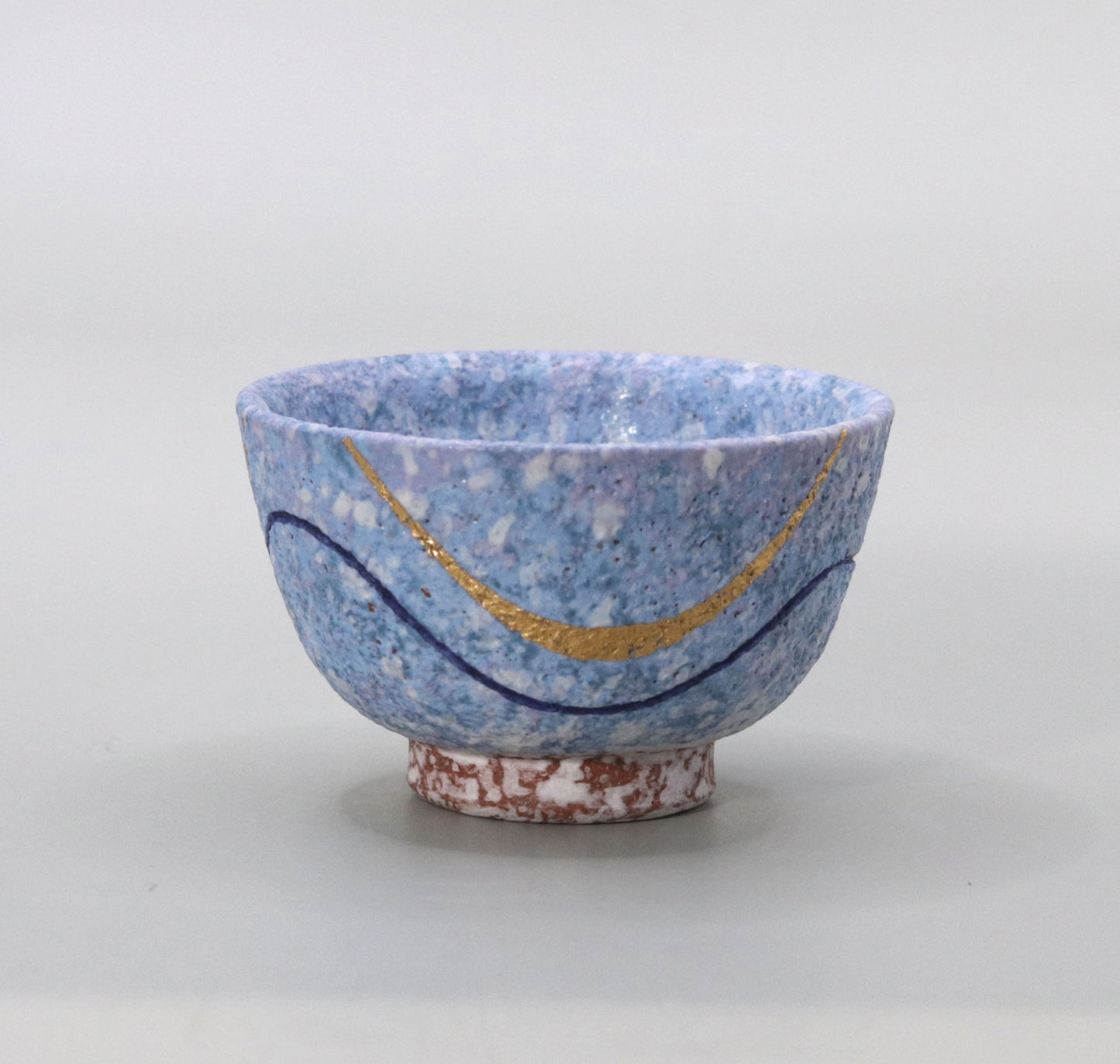 Blown mud gold and blue sake cup by Ichiji Shimizu