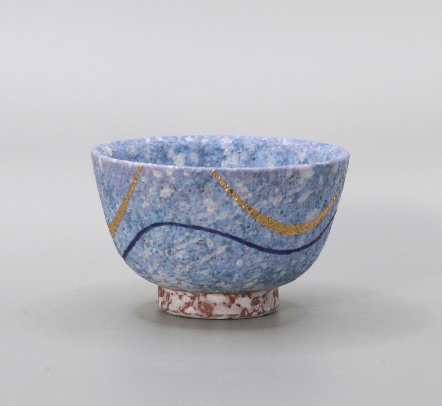 Blown mud gold and blue sake cup by Ichiji Shimizu