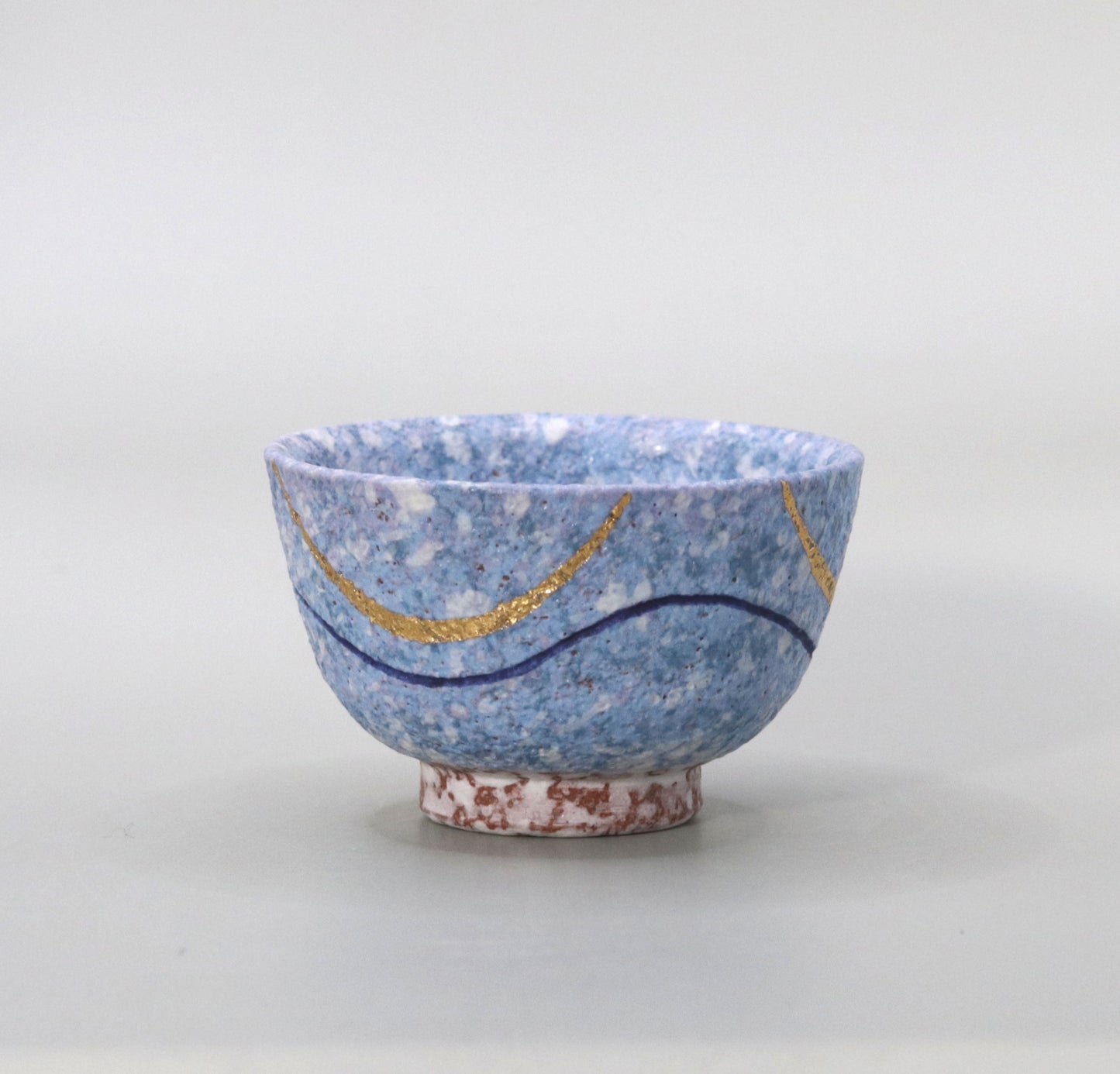 Blown mud gold and blue sake cup by Ichiji Shimizu